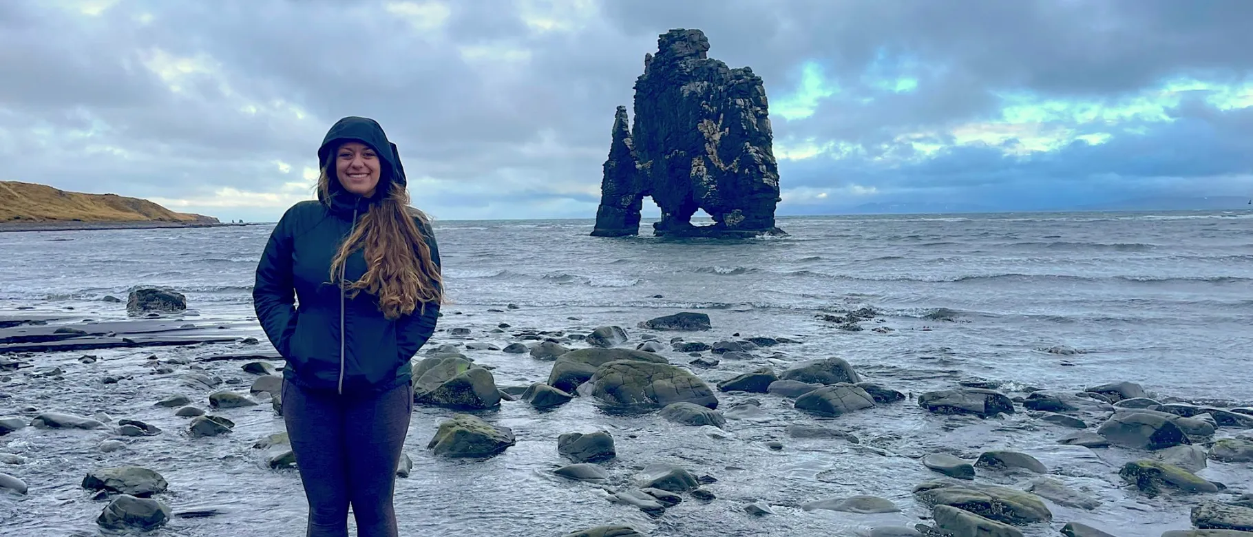 Ariana Telzerow stands in front of the water in Iceland