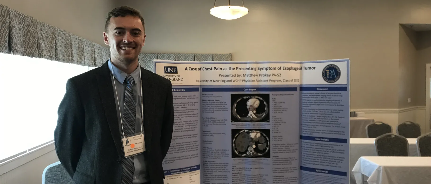 PA student Matt Prokey stands next to a poster he presented