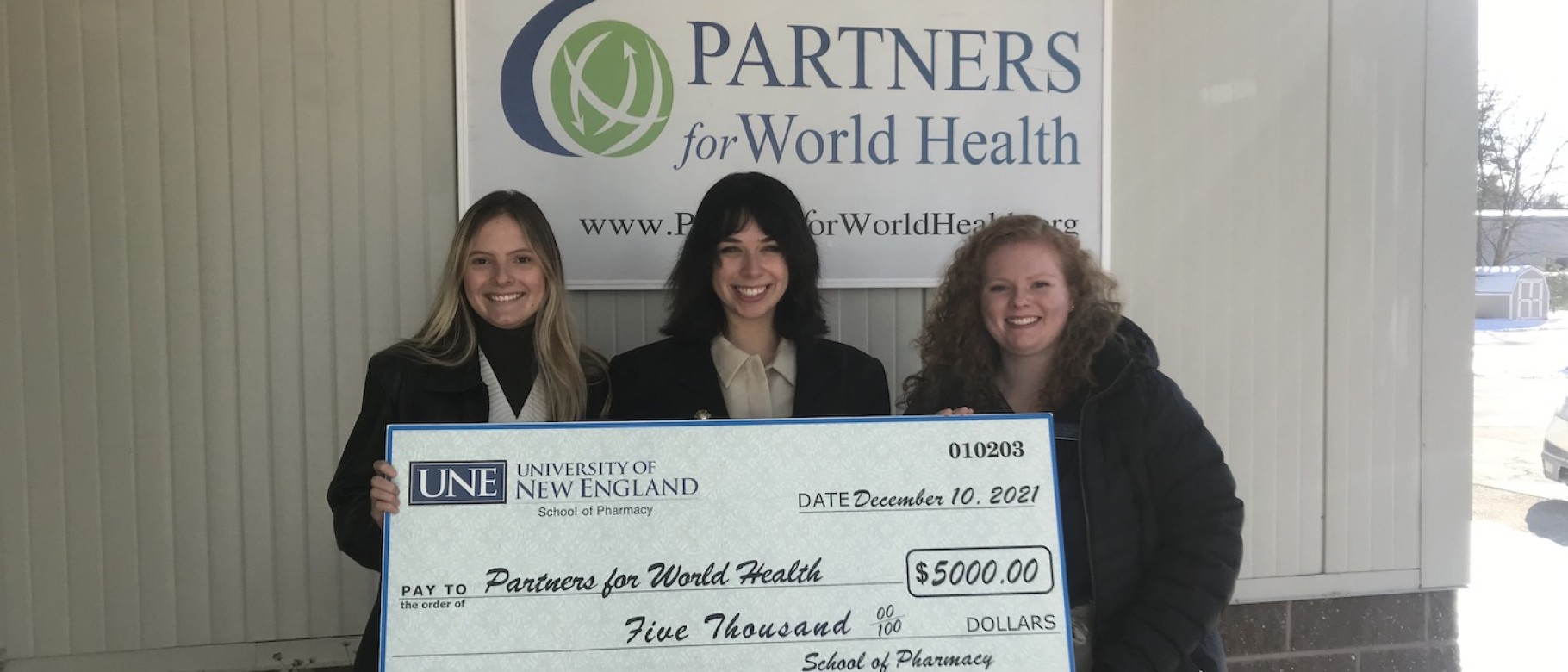 Pharmacy students with giant check