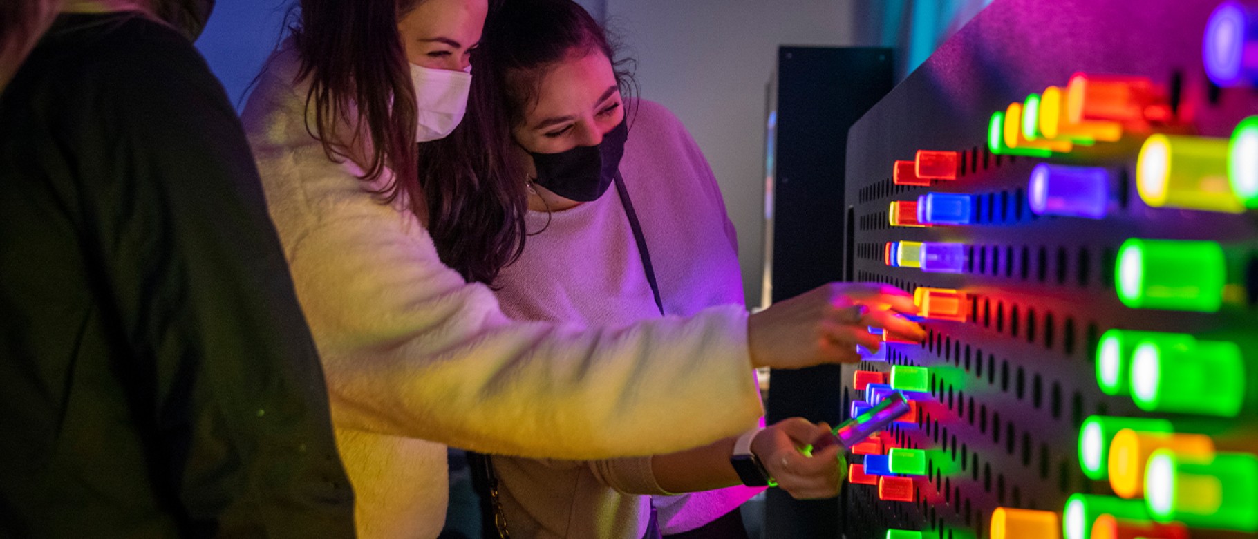Students play with a giant "Lite Brite" at the children's museum