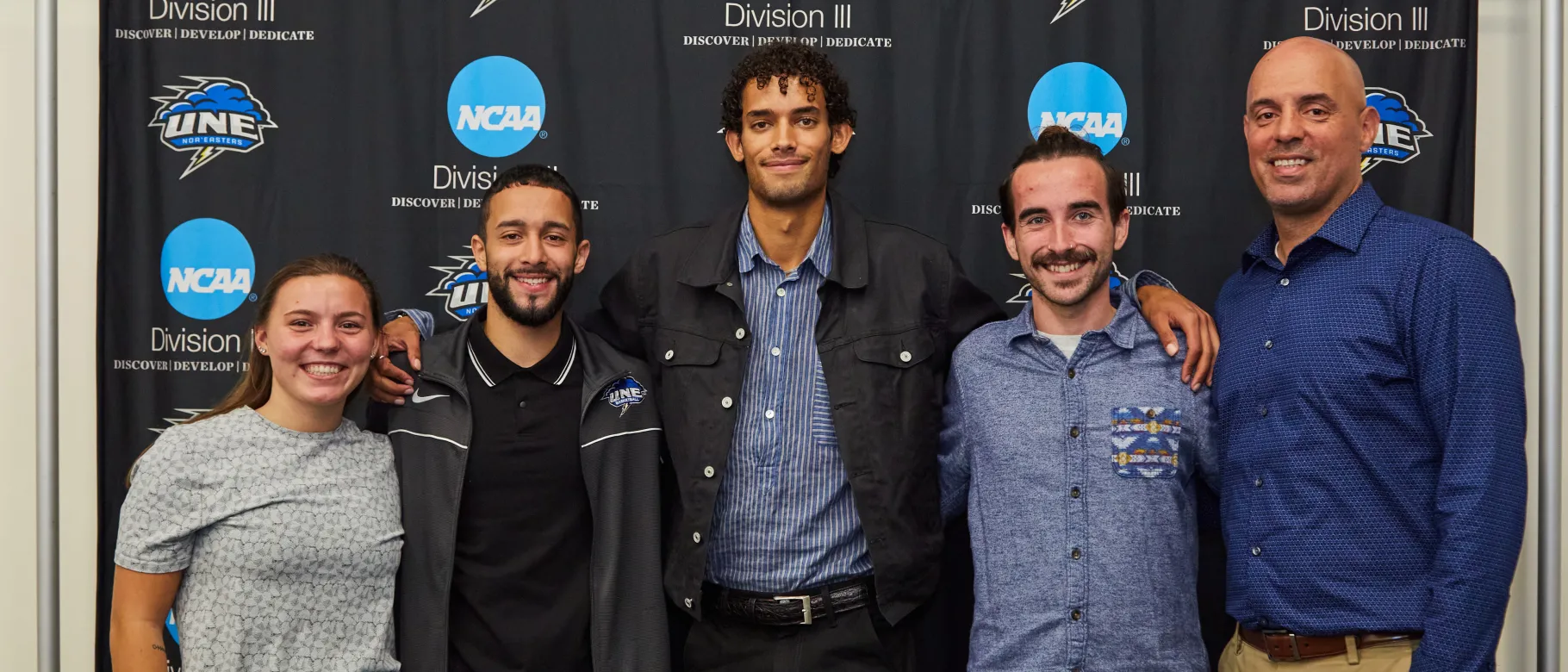 Kena Gilmour poses with Storming to Change students and Ed Silva 