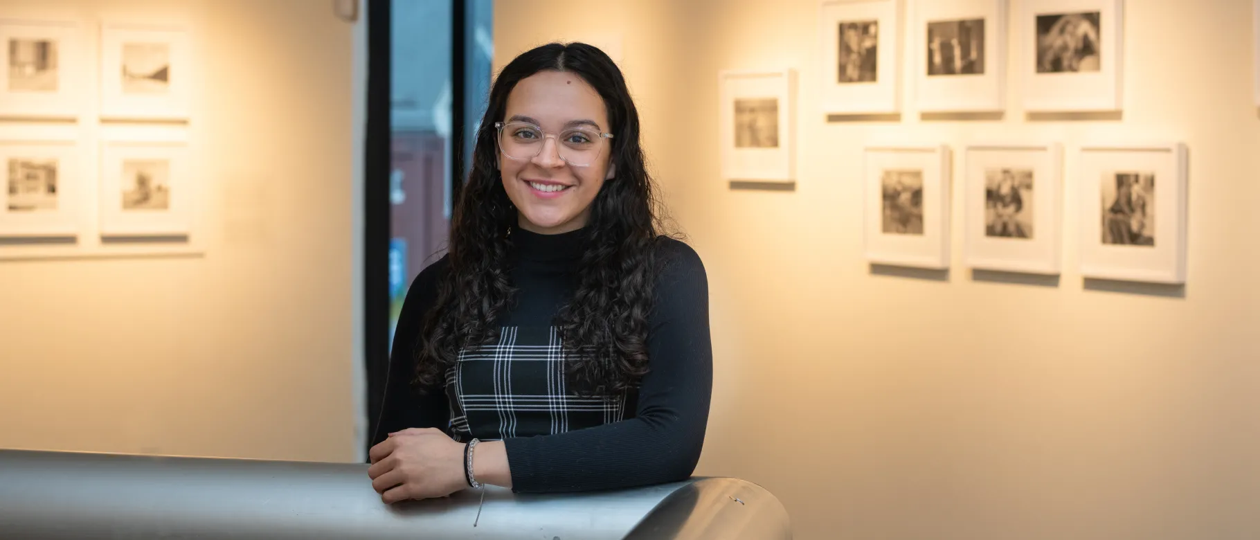 Portrait of Rhetta Vega against the walls of the UNE Art Gallery