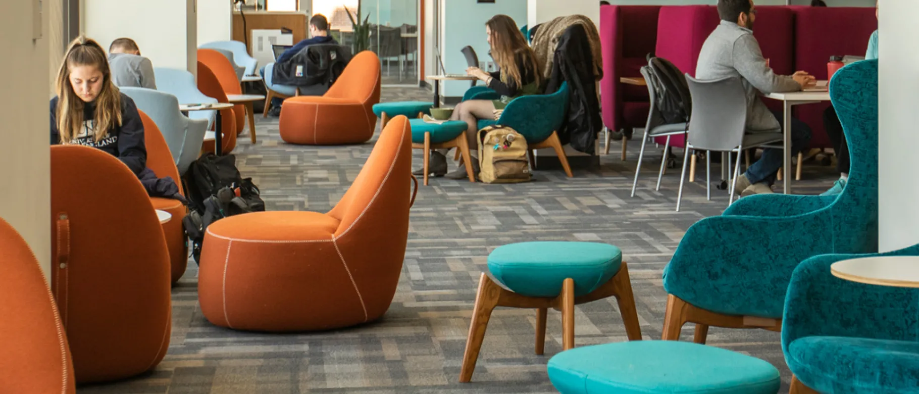 Several students studying in the Commons