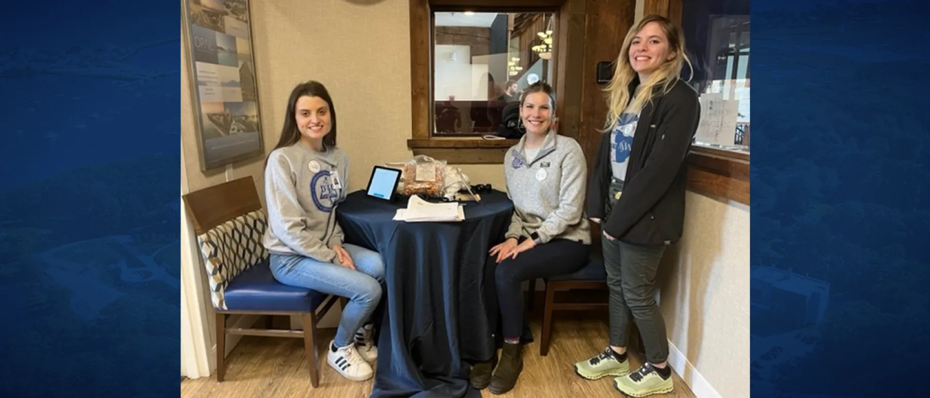 Three woman students pose for a photo