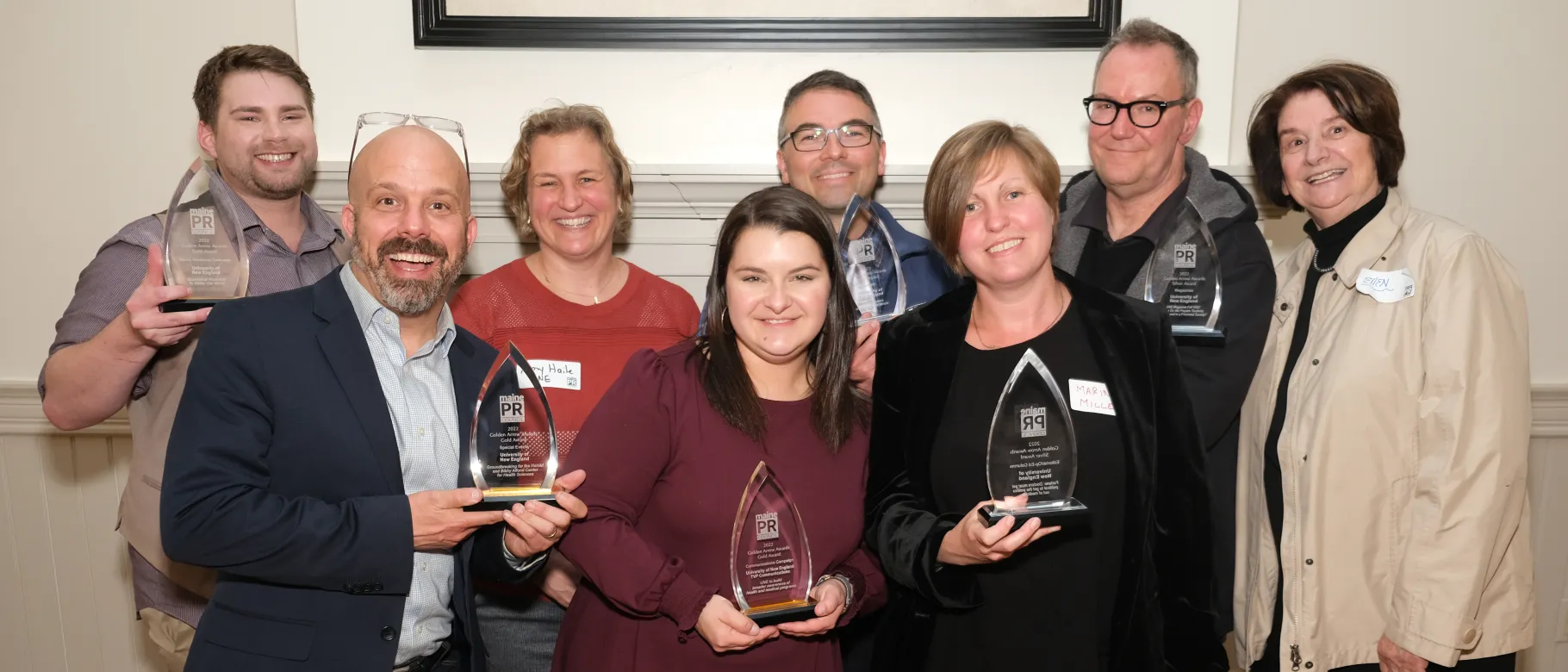 Members of UNE's Communications Office pose with their Golden Arrow awards