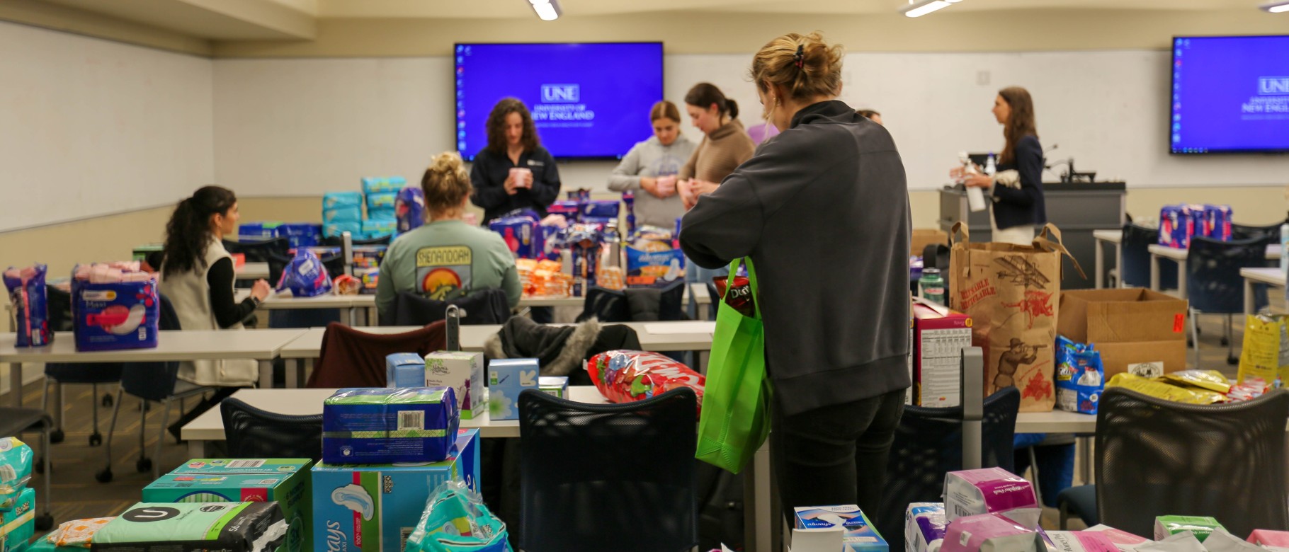 students filling kits full of reproductive health supplies