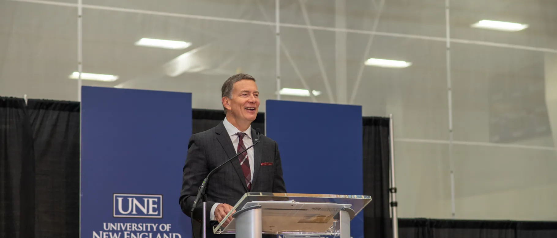 president herbert stands at podium during fall assembly