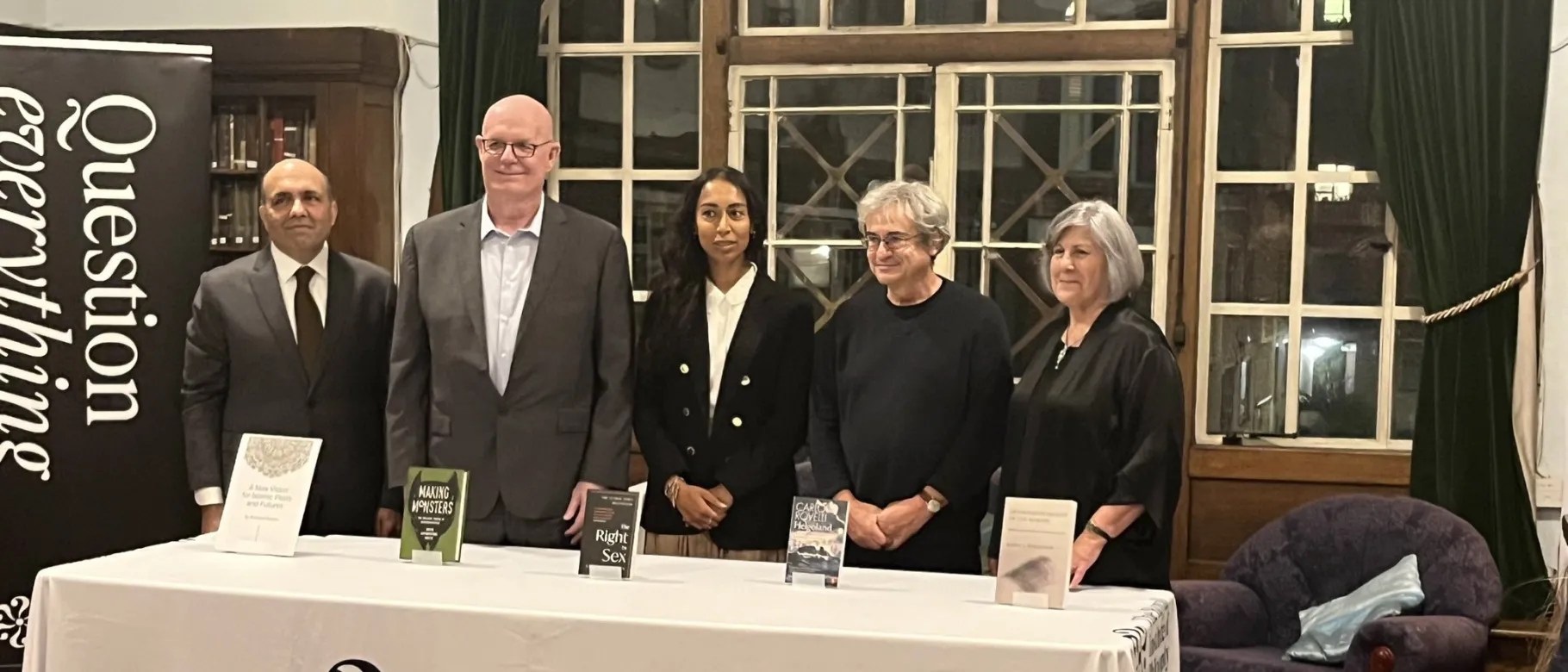 A photo of the prize finalists standing behind a table bearing the Royal Institute of Philosophy's name and logo