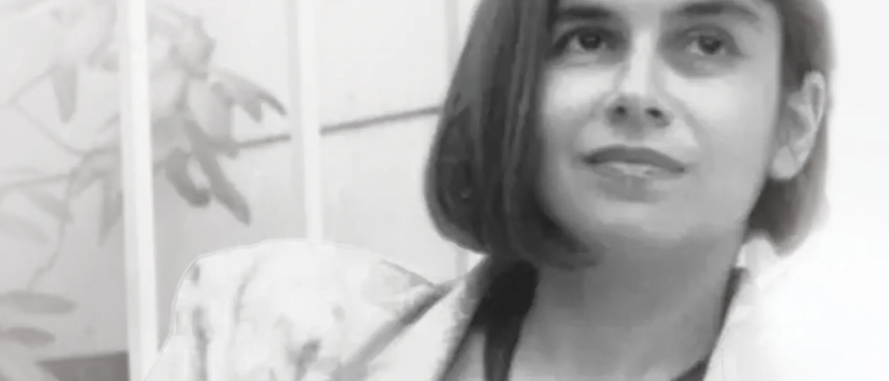 A black and white photo of a woman looking off-camera