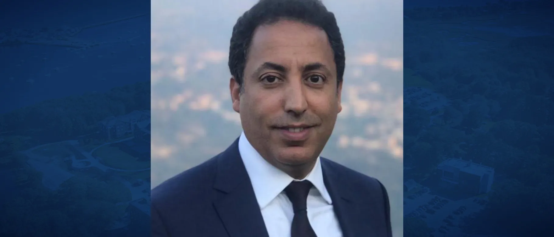 Headshot of Younes Abouyoub against a blue backdrop