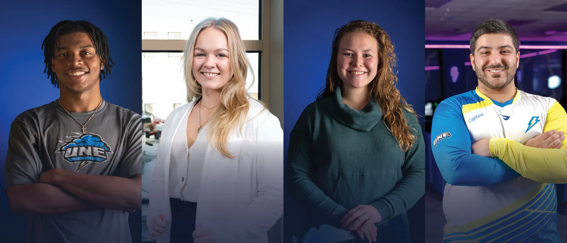 Four UNE students pose and smile