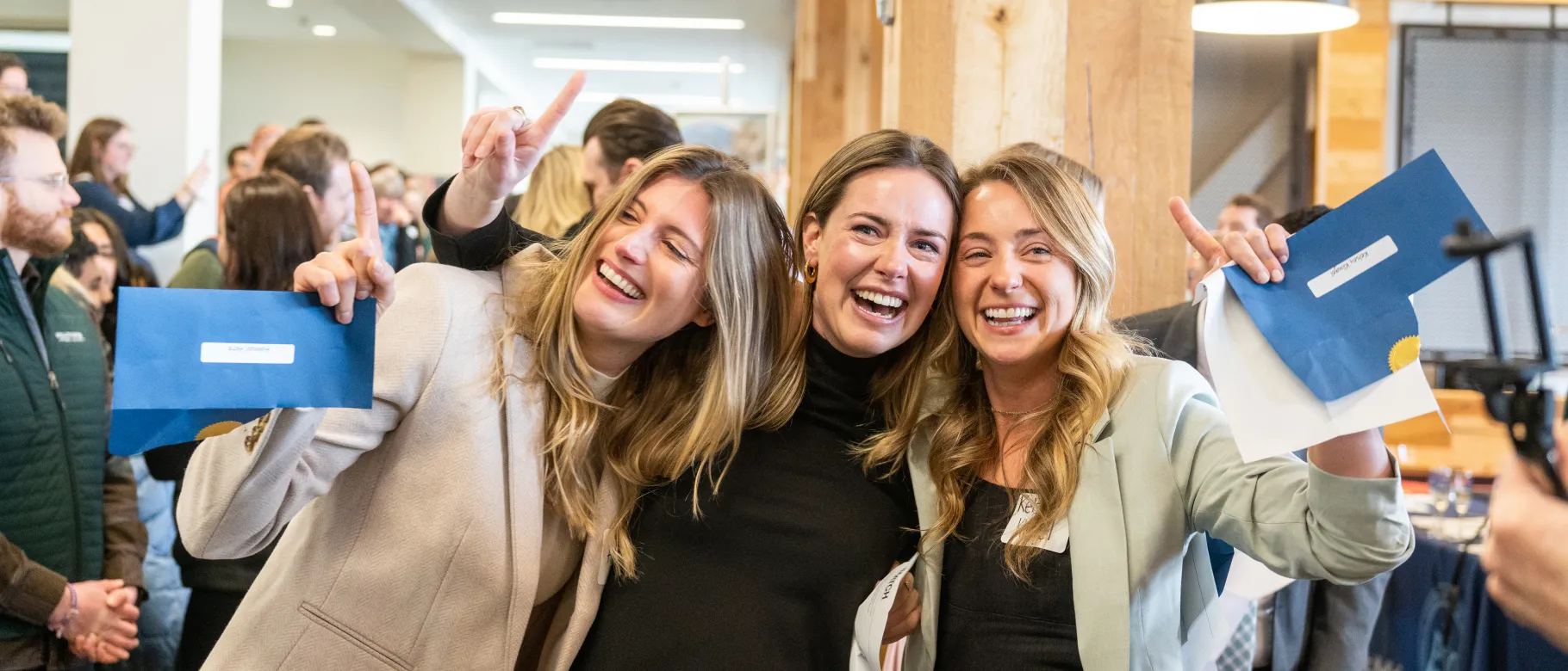 Three female students hug after learning their residency matches