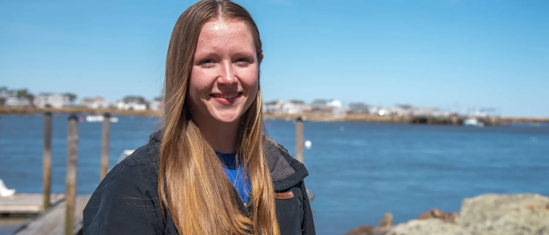 Portrait of a woman smiling in front of the ocean