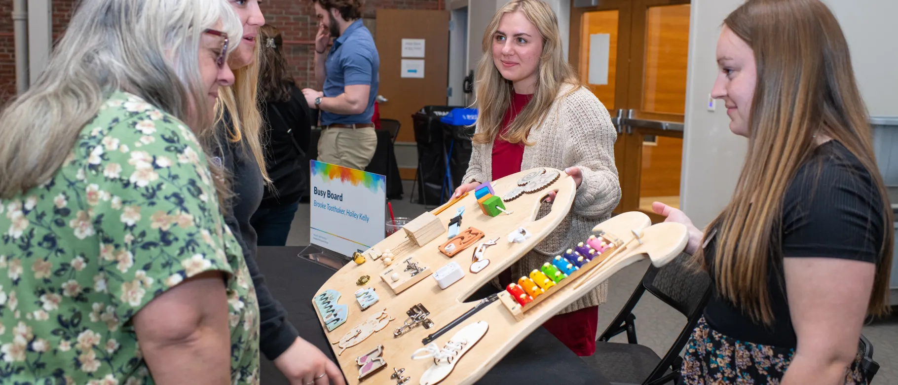 People observe a sensory board 