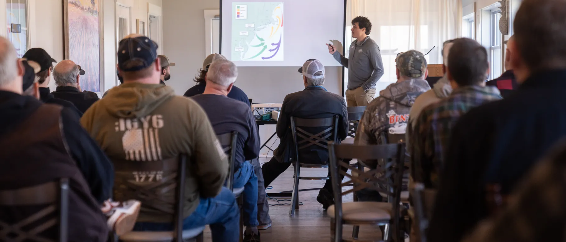 A student presents a slideshow to a room of people