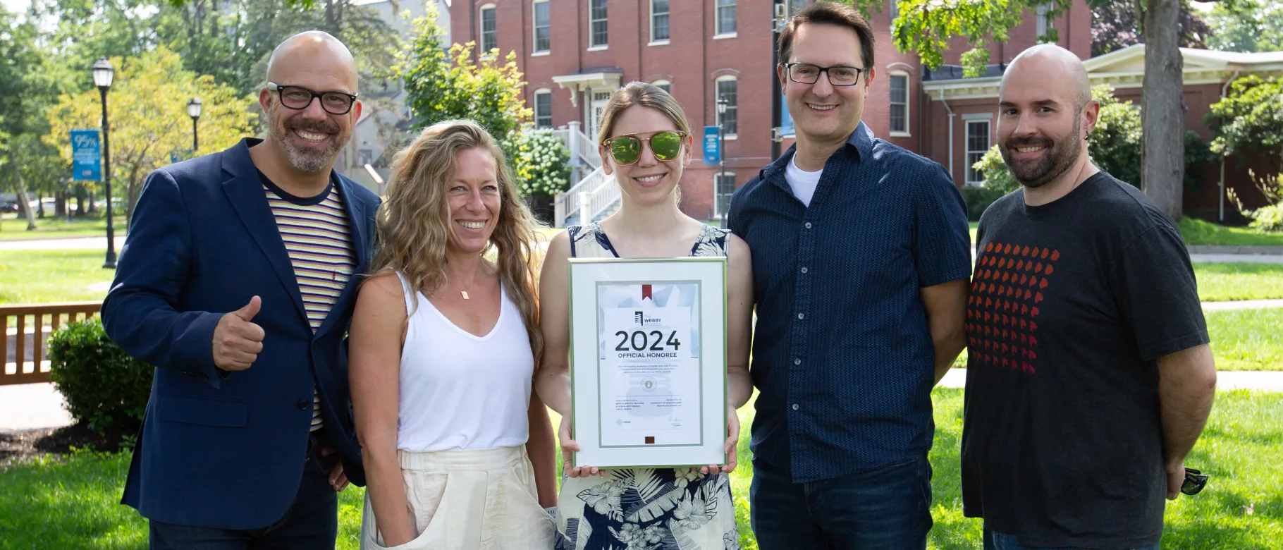 Members of UNE's Communications Office and Redfin Solutions pose with their 2024 Webby Awards