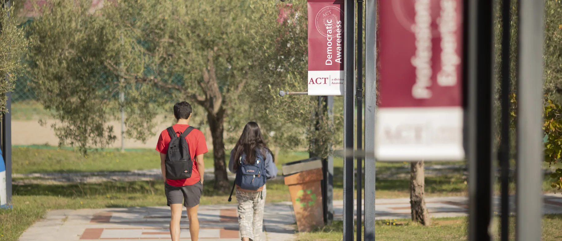 Students walk along a path at the American College of Thessaloniki in Greece