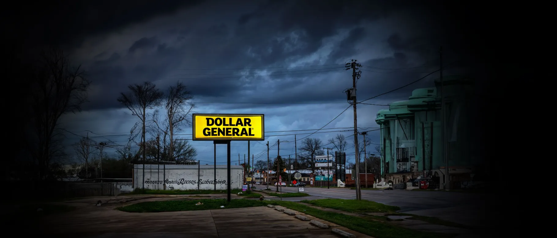 A Dollar General sign is illuminated against a dark sky