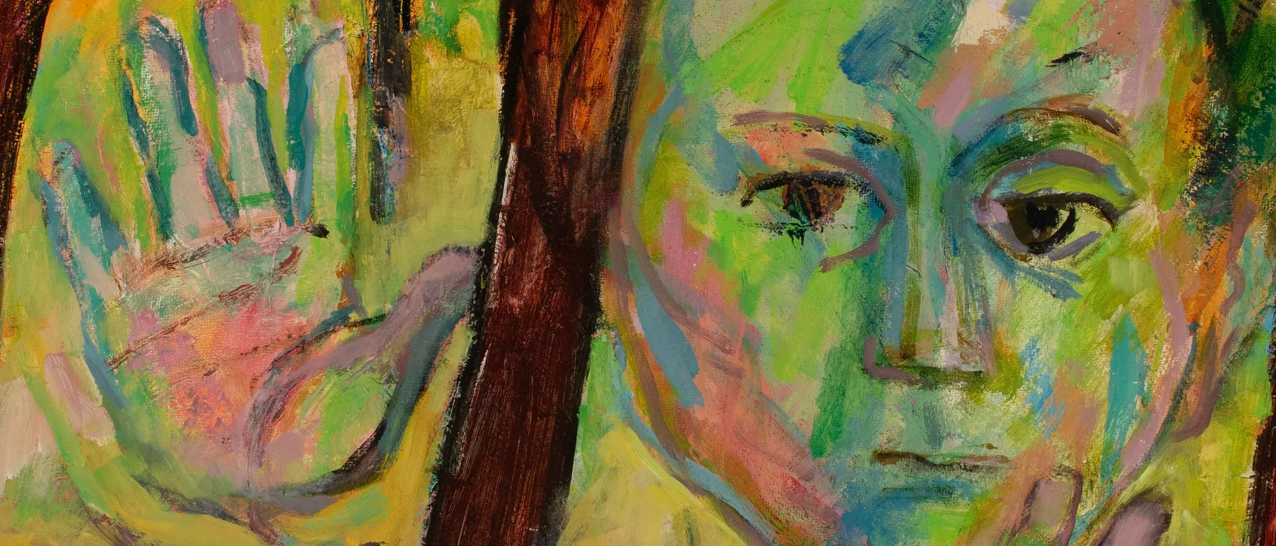 A child is painted in various shades of green