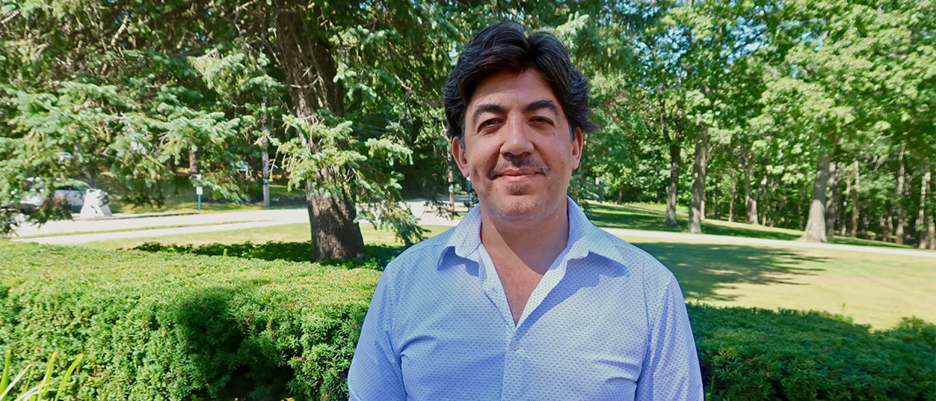 Moustafa Abu El Fadl stands outside on a sunny day