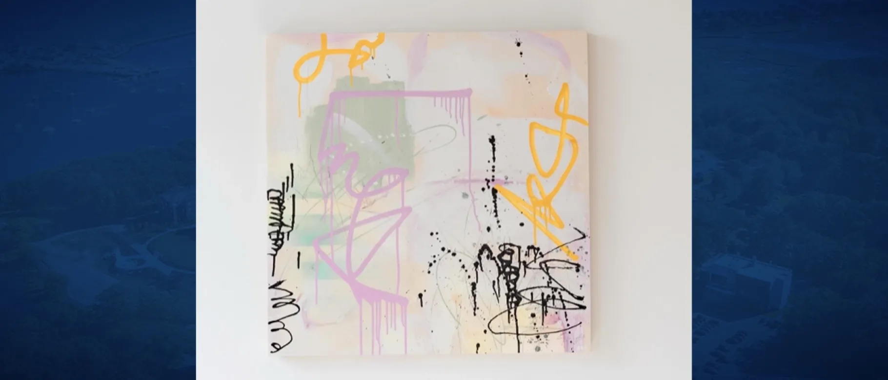 An abstract painting in pastel colors against a white wall