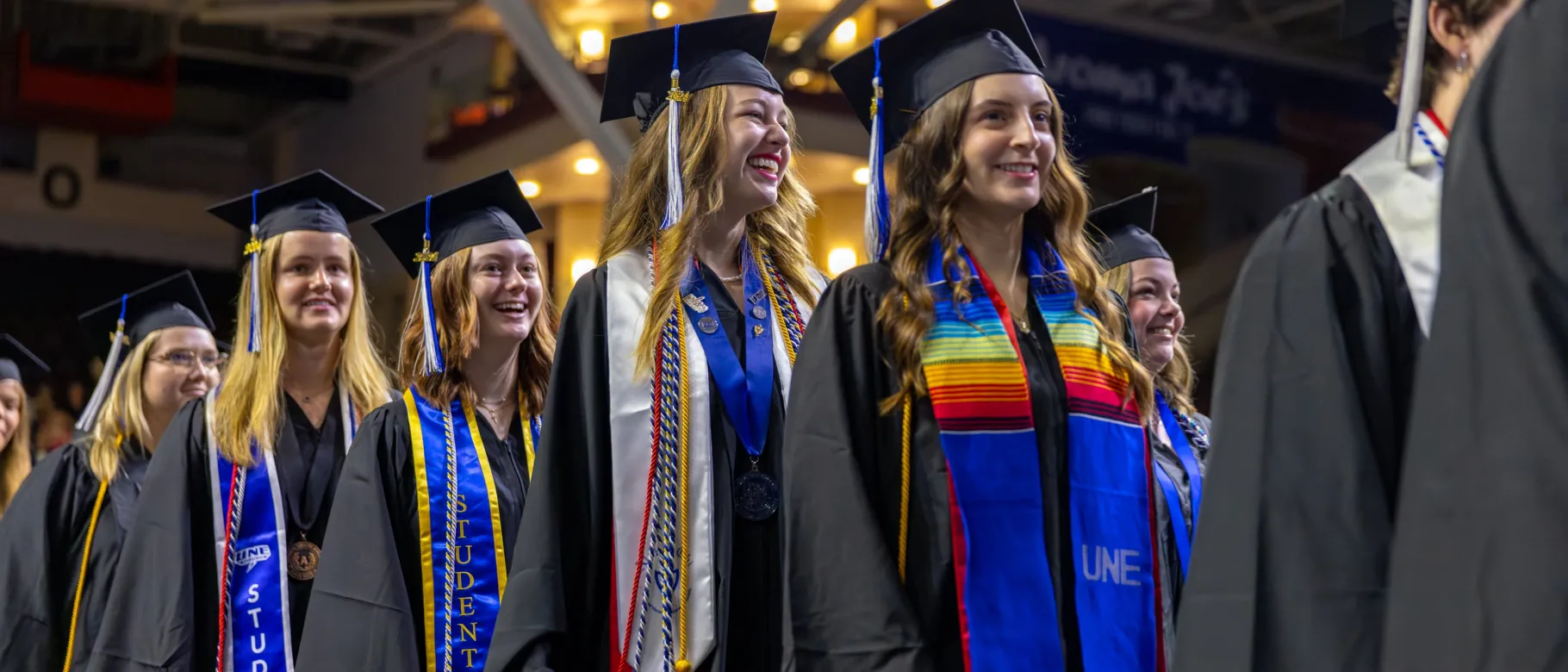 UNE students walk into the 2024 Commencement ceremony