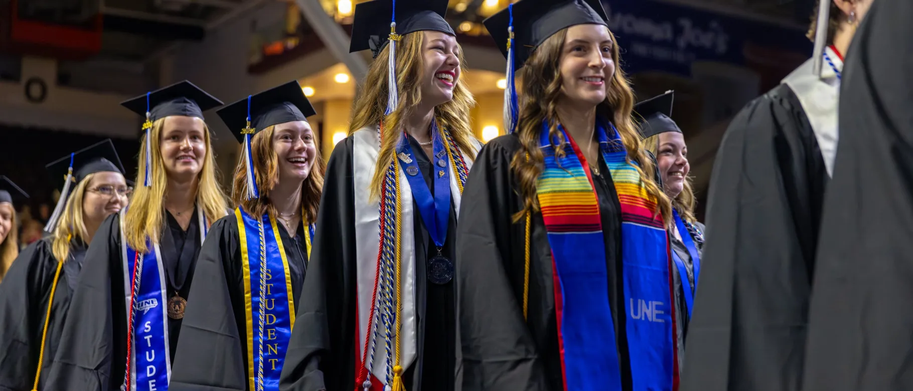 UNE students walk into the 2024 Commencement ceremony