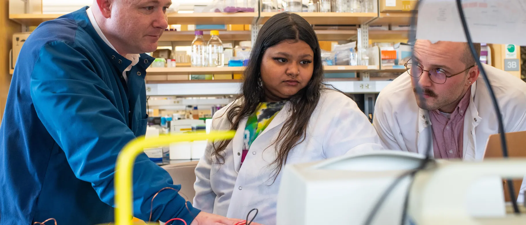 Researchers examine data in the Portland Laboratory for Biotechnology and Health Sciences