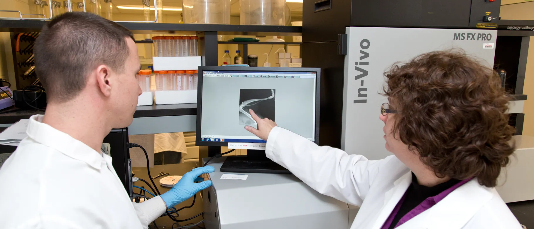 Tamara King works with a student in her research lab