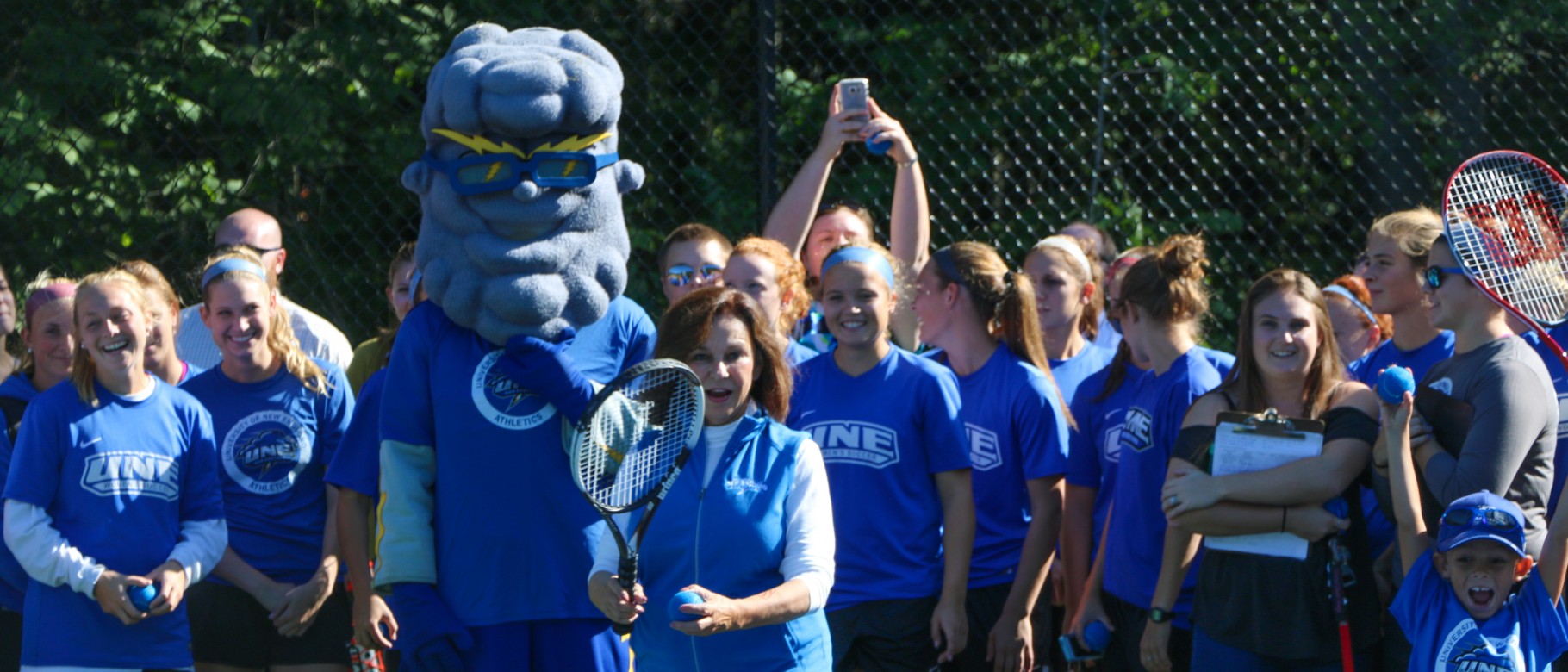 President Danielle Ripich delivers ceremonial First Serve at UNE's new tennis courts