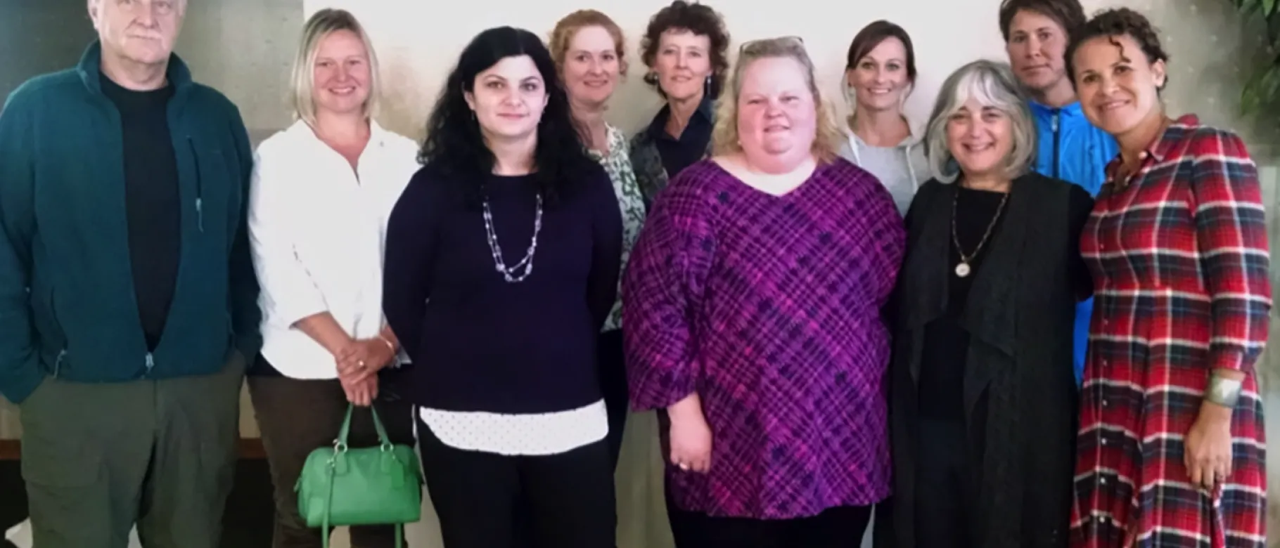 Shelley Cohen-Konrad and Arabella Perez with several graduates of the UNE School of Social Work