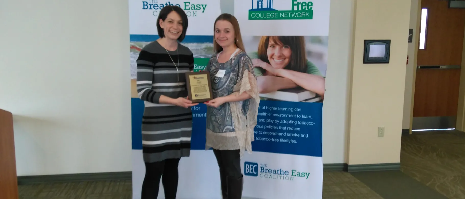 Cat Martins, UNE benefits and disability specialist, accepts the award
