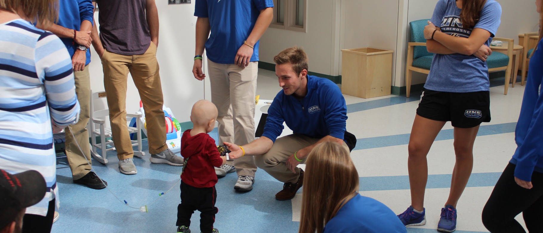 UNE lacrosse players visit patients at Barbara Bush Children's Hospital