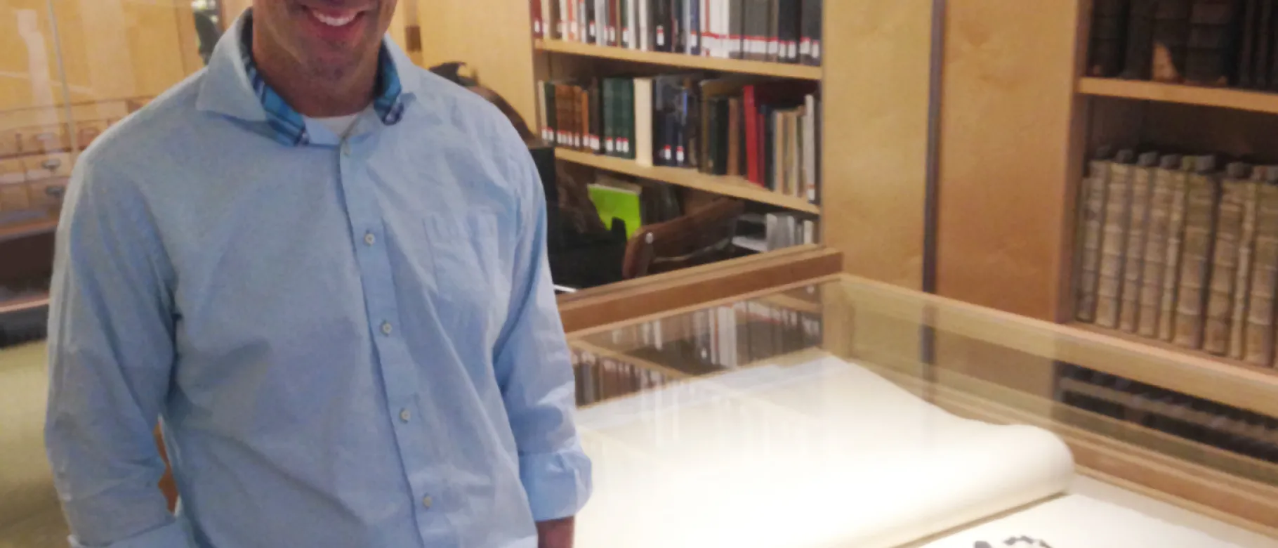 Noah Perlut stands beside Bowdoin College’s copy of the double-elephant folio edition of Audubon’s Birds of America. The red-he