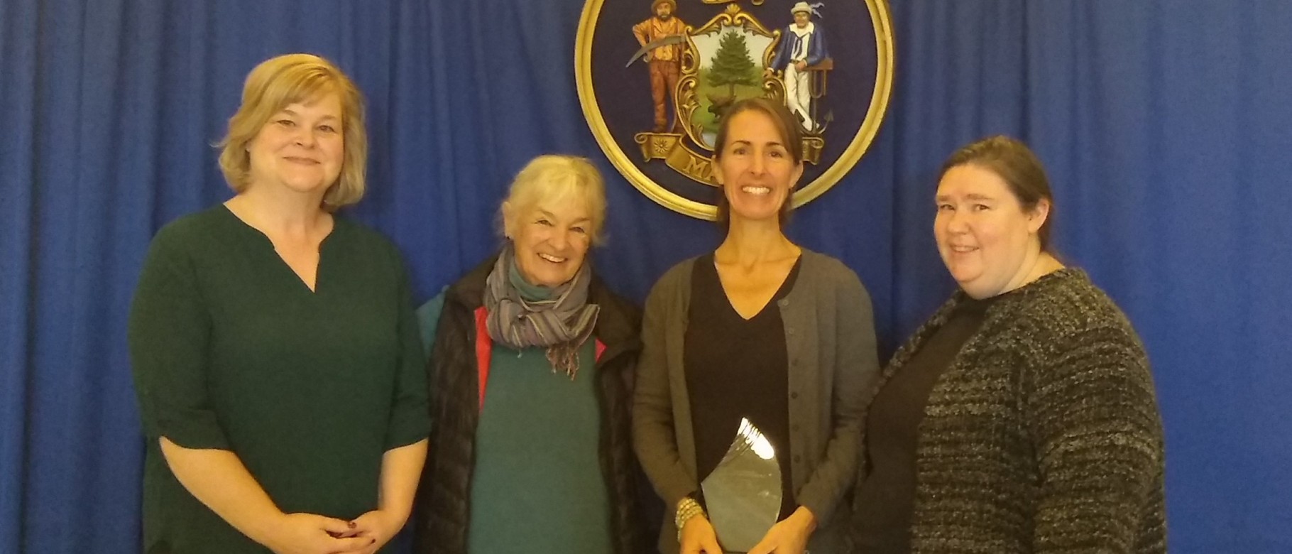 Jen Gunderman (second from left) received the award during a ceremony at the Maine Statehouse