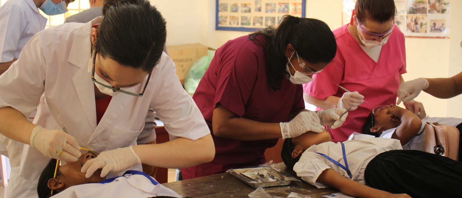 Lindsey Cunningham, Tara Prasad and Nicole Kimmes provide care to children in a primary school in Phnom Penh