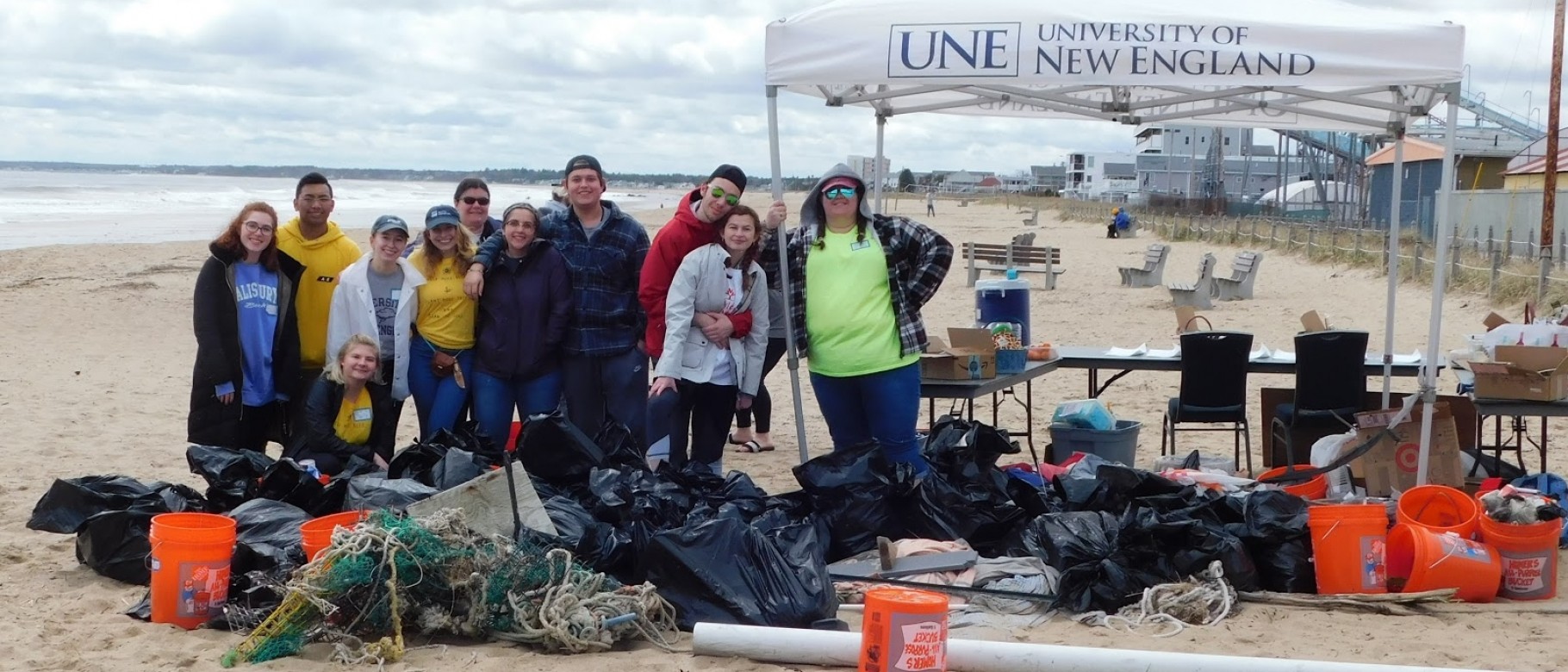 A UNE-led team of volunteers cleared 500 pounds of trash off the beach in Old Orchard Beach