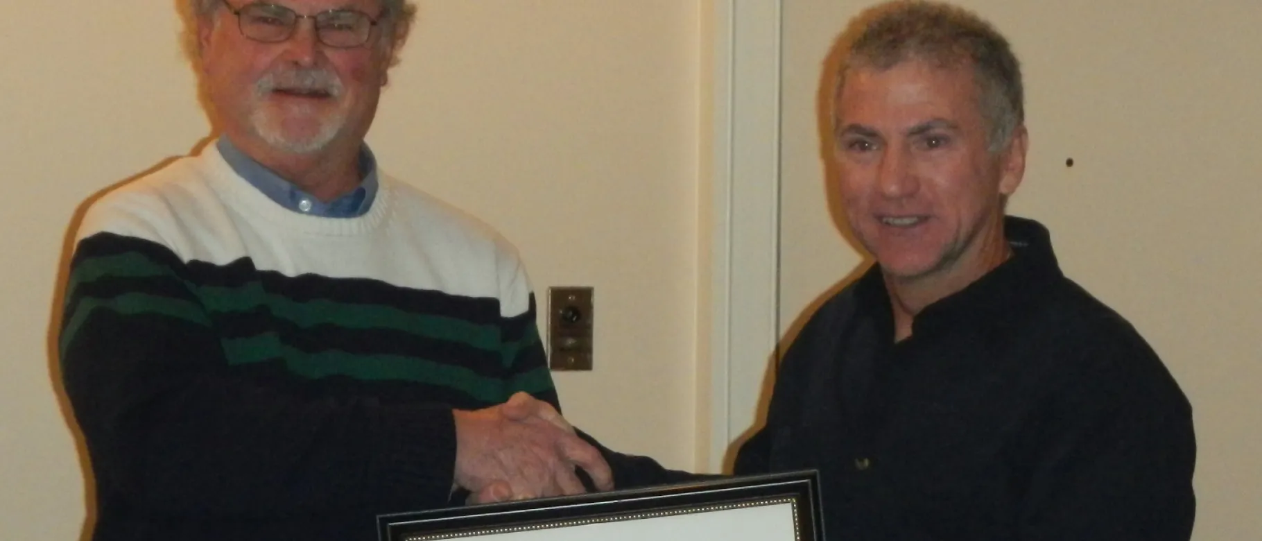 William J. Kirmes, D.O., presented the distinguished service award to UNE College of Osteopathic Medicine alum David Duval, D.O.