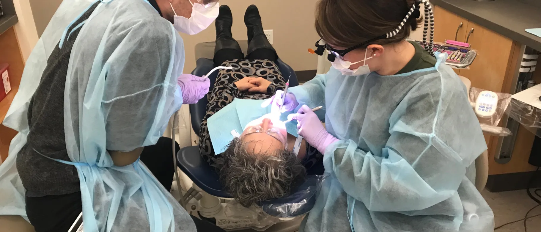College of Dental Medicine students Chris Priest and Stephanie Beeckel provide free dental care at the Oral Health Center