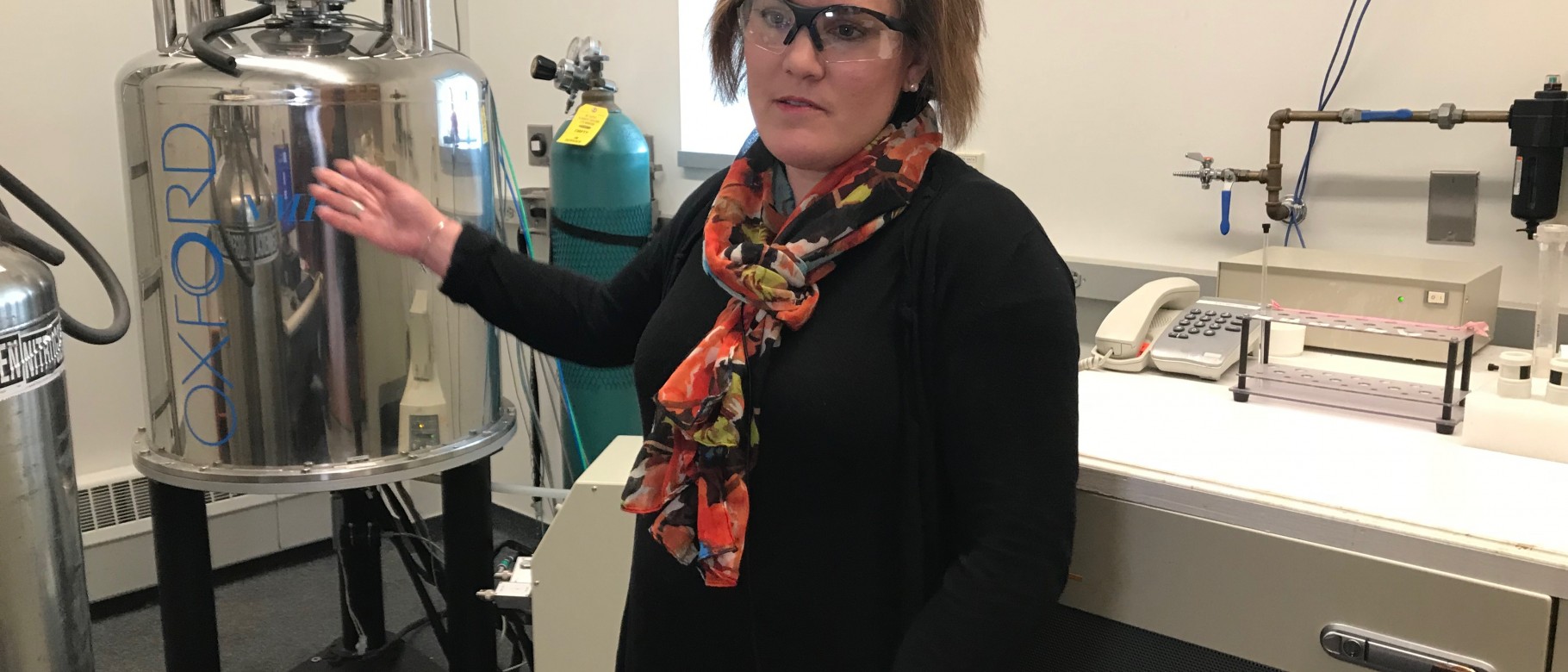 Amy Deveau shows off some of the tools in her lab that require helium