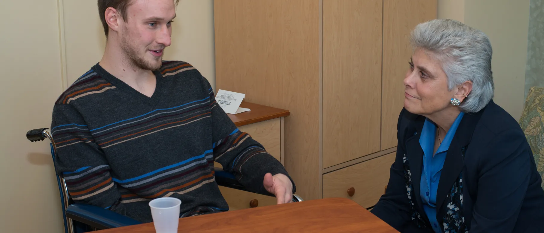 Marilyn Gugilucci works with  UNE COM student in the Learning by Living program