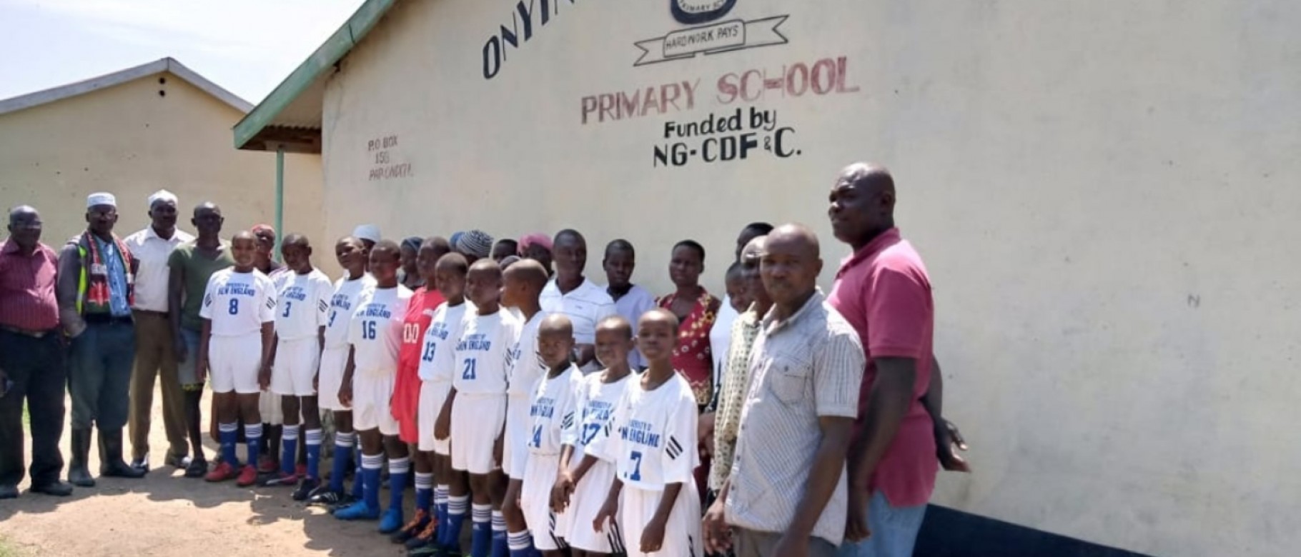 Students in Kenya wear uniforms donated by the UNE soccer program
