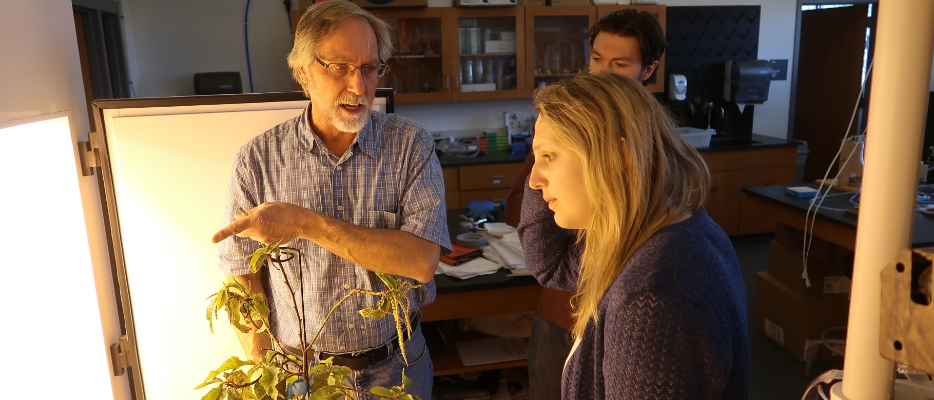 Thomas Klak discusses the seedling speed breeding process with Sarah Stanley of the Kennebunk Land Trust