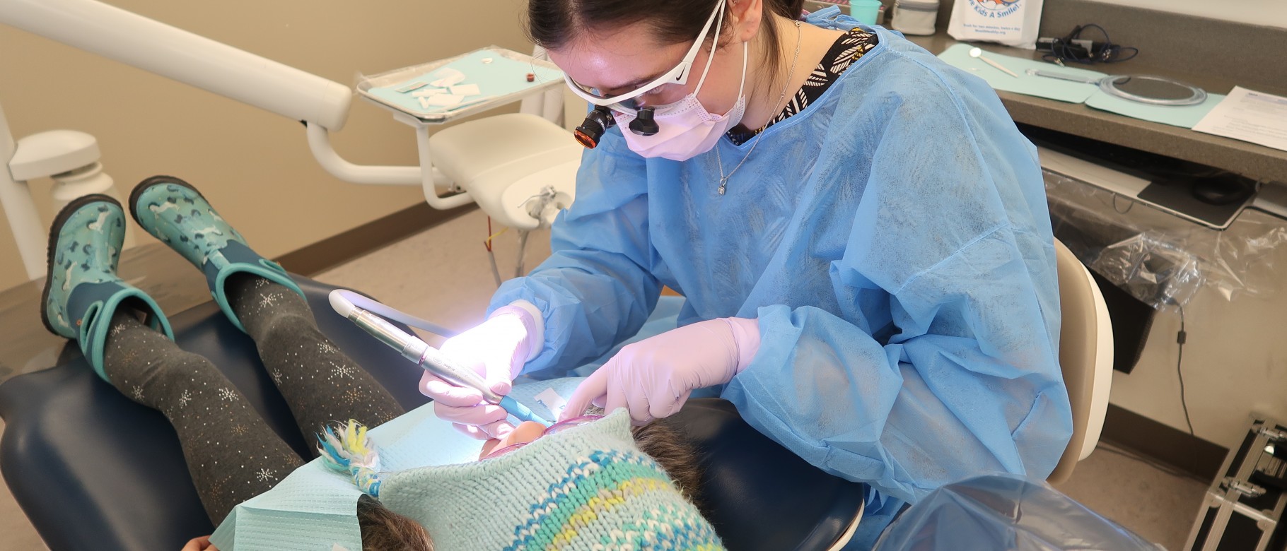 Dental student Emily Richard provides a cleaning during the Give Kids A Smile event