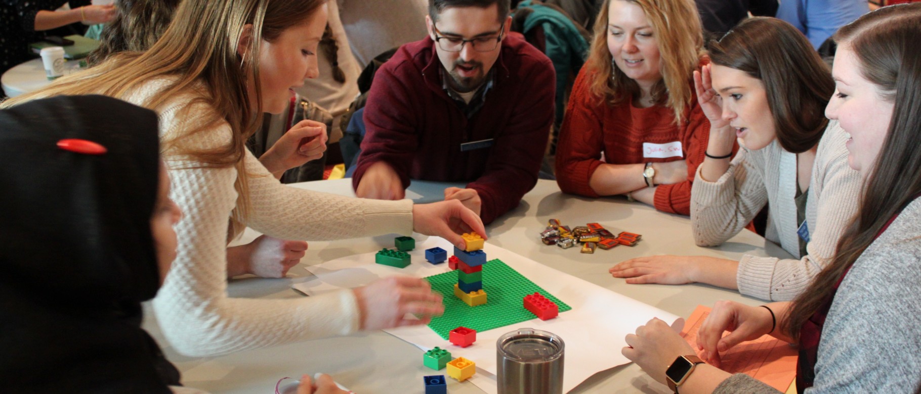 Students from various colleges within the University of New England work together during a collaborative learning activity.