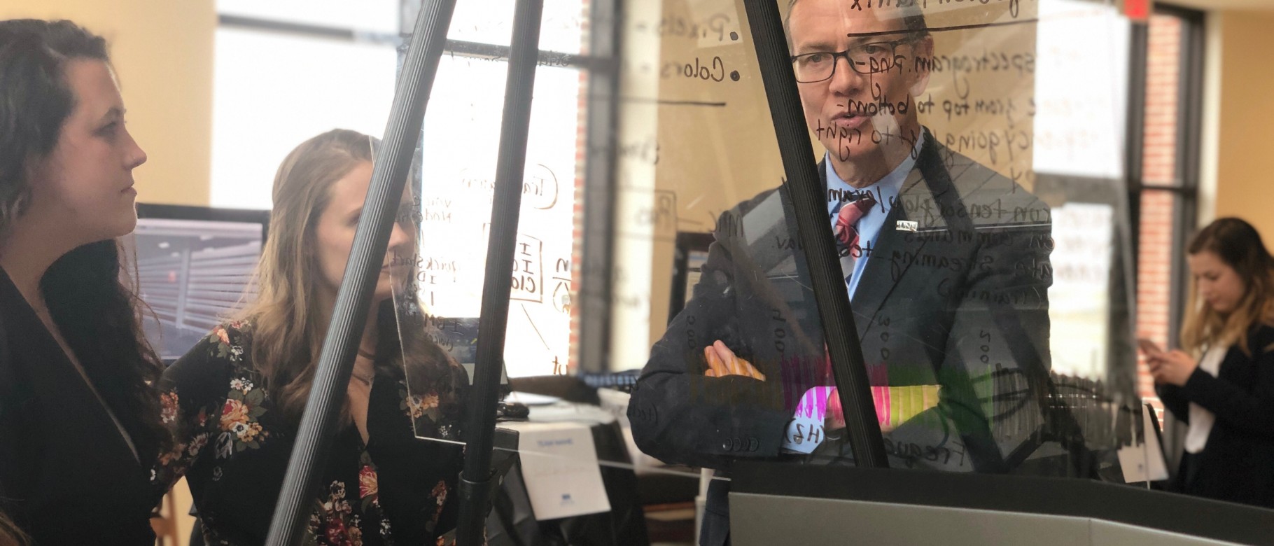 President James Herbert looks at a student project at the 2019 Student Innovation Challenge