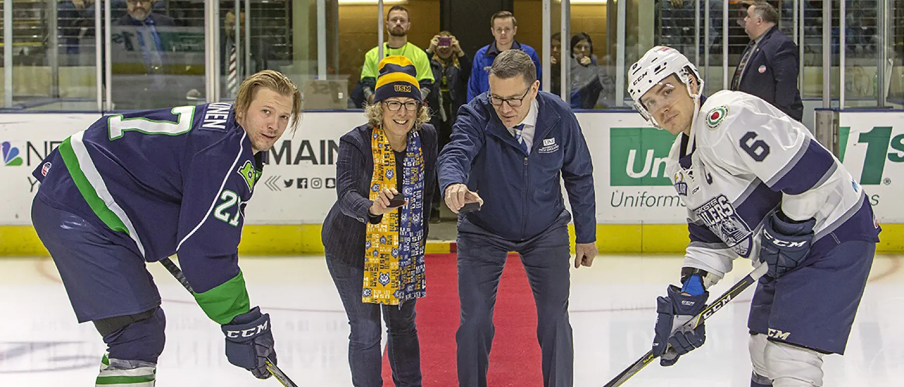 President James Herbert joins USM Provost Jeannine Uzzi to drop the puck at Maine Mariners game