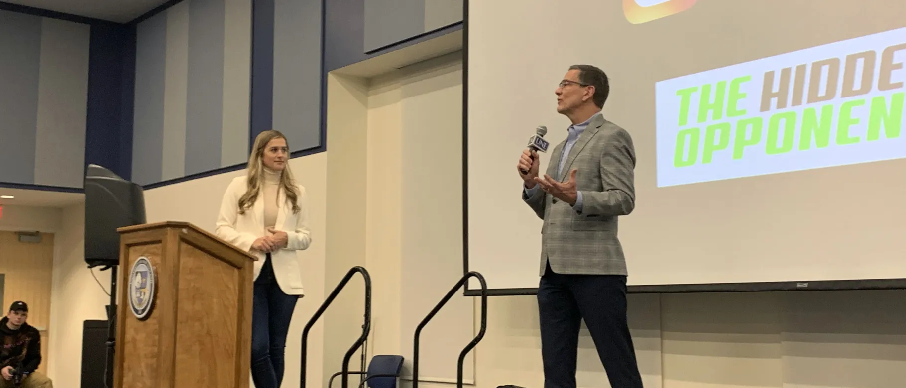 UNE President James Herbert addresses the crowd following a presentation by athlete and motivational speaker Victoria Garrick.