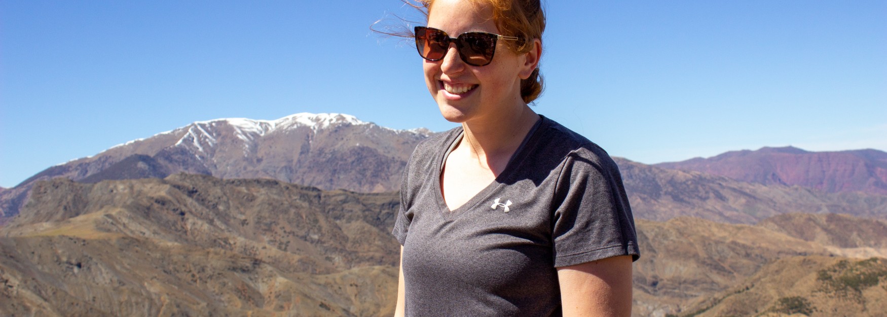 Rebecca Kryceski stands against a backdrop of the Sahara Desert