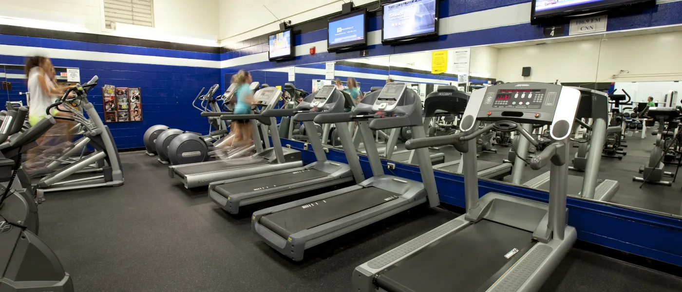 Female students use treadmills at the U N E Fitness Center